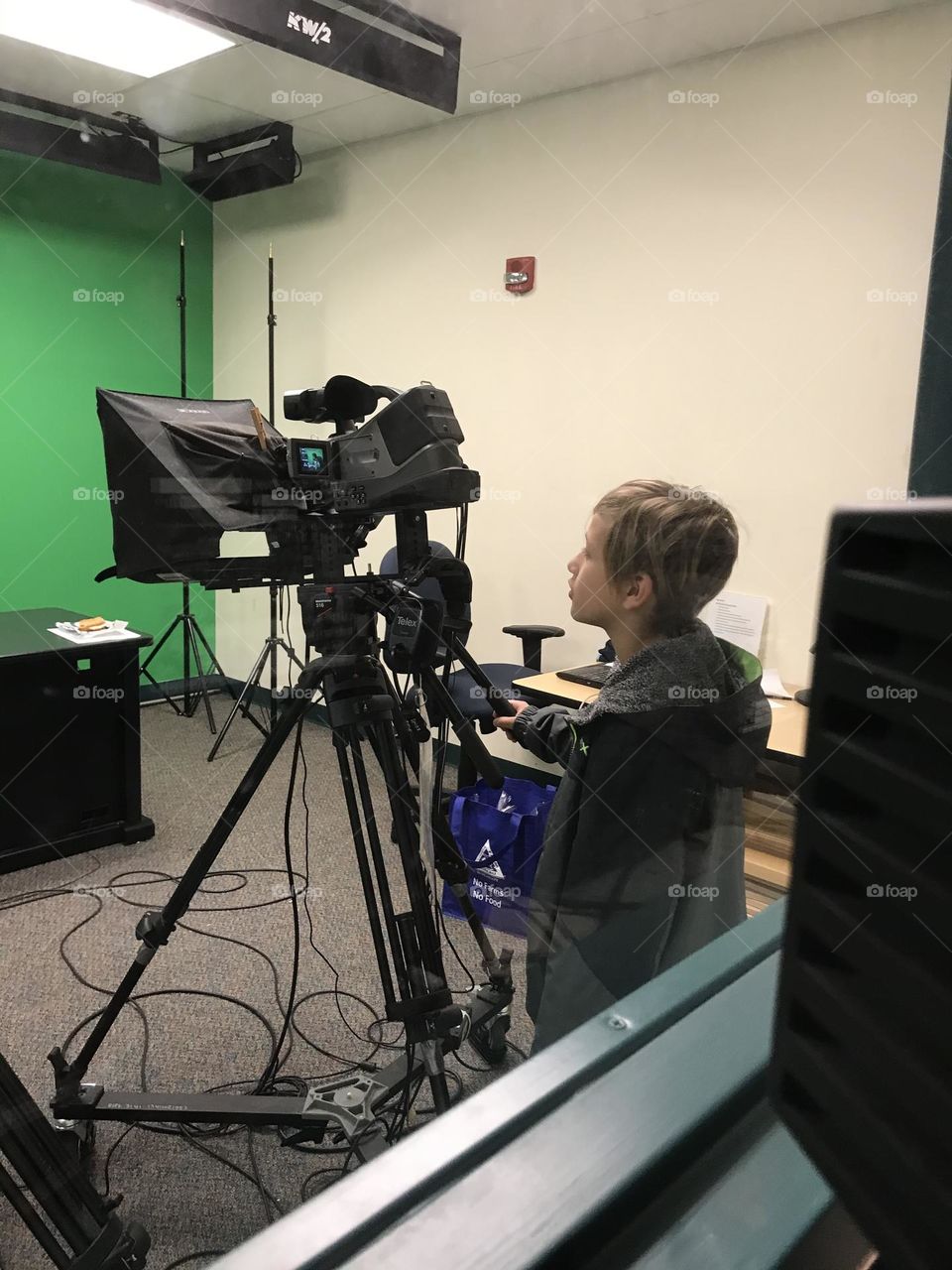 Boy behind camera during TV crew