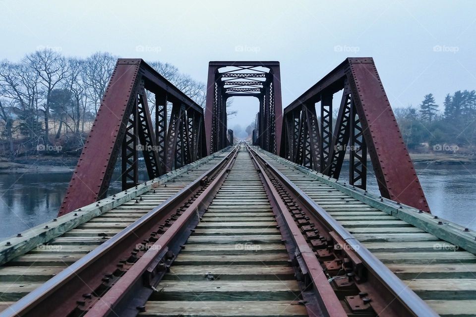 “The Crossing”.  A trestle bride beckons passage across a river on a misty, atmospheric evening.