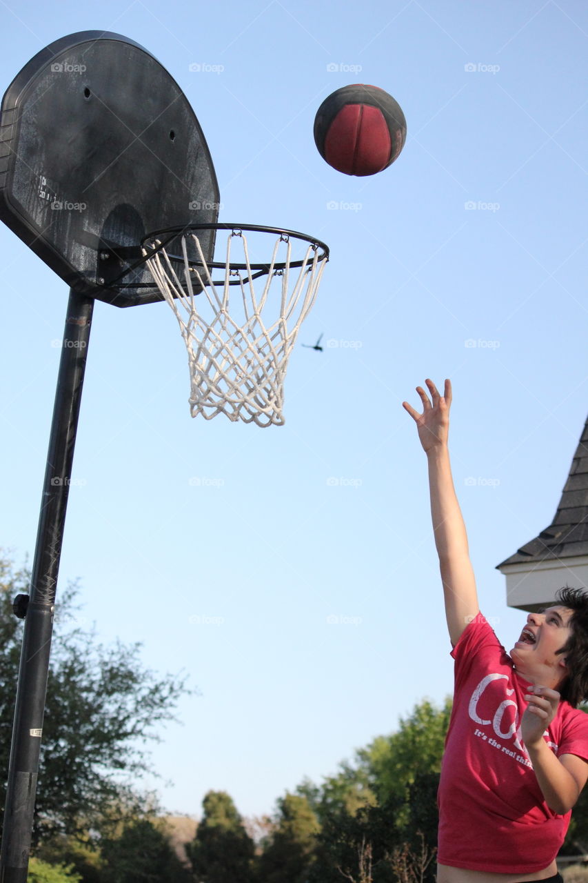 Determination. Boy trying to dunk