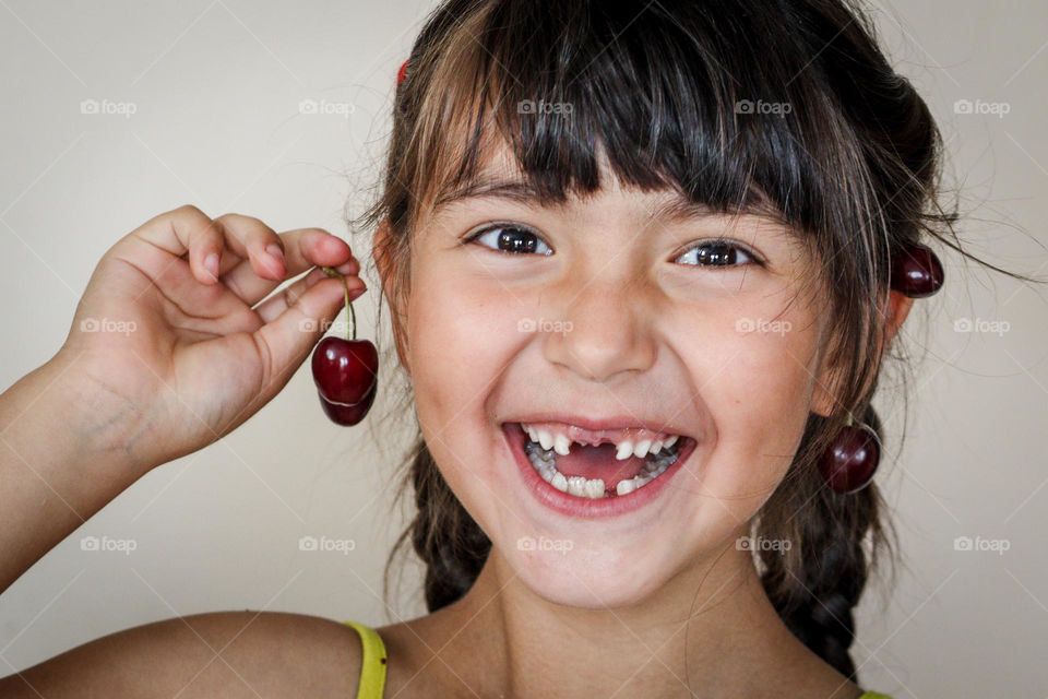 Happy girl with cherry