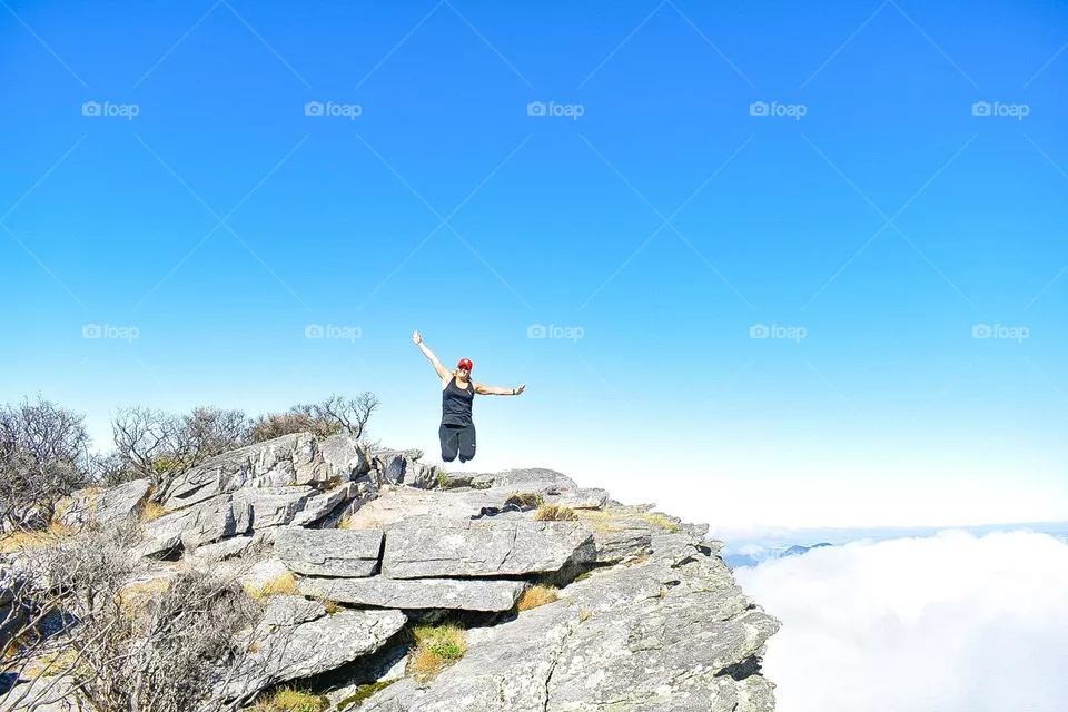 Jumping at the summit of hike