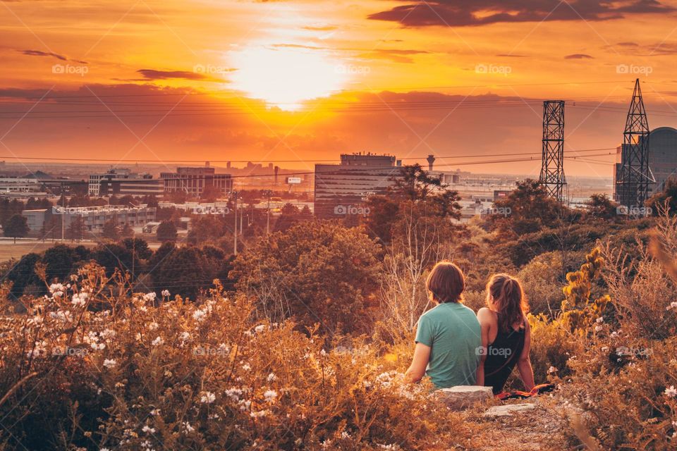 Teen couple is watching a sunset