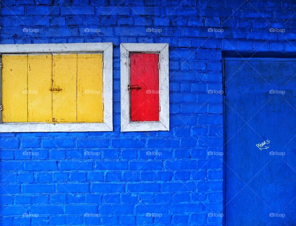 Blue building with yellow and red window