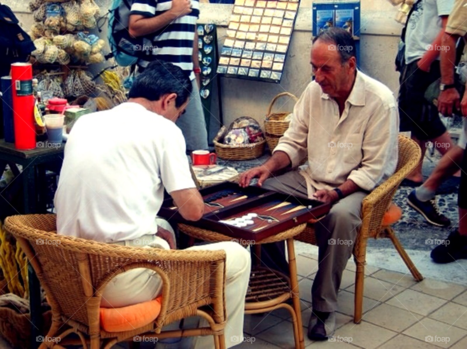 Greek men playing taula. Greek men at Santorini playing taula a Greek game