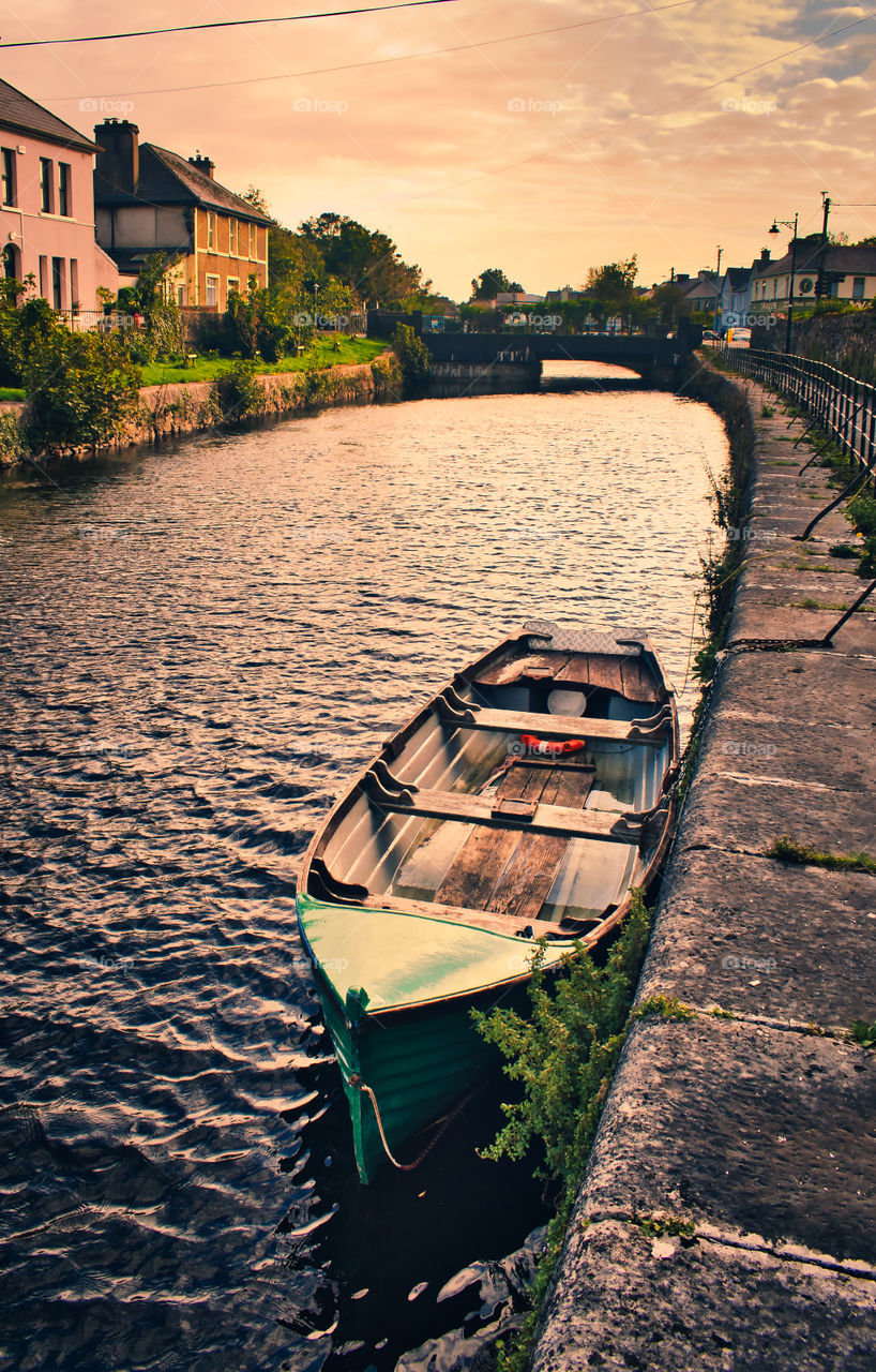 Old wooden boat in the canal of river Corrib at Galway city, ireland