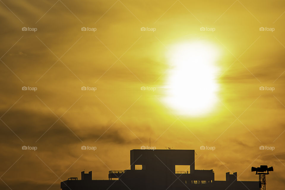 The early morning sunlight shining on large buildings.