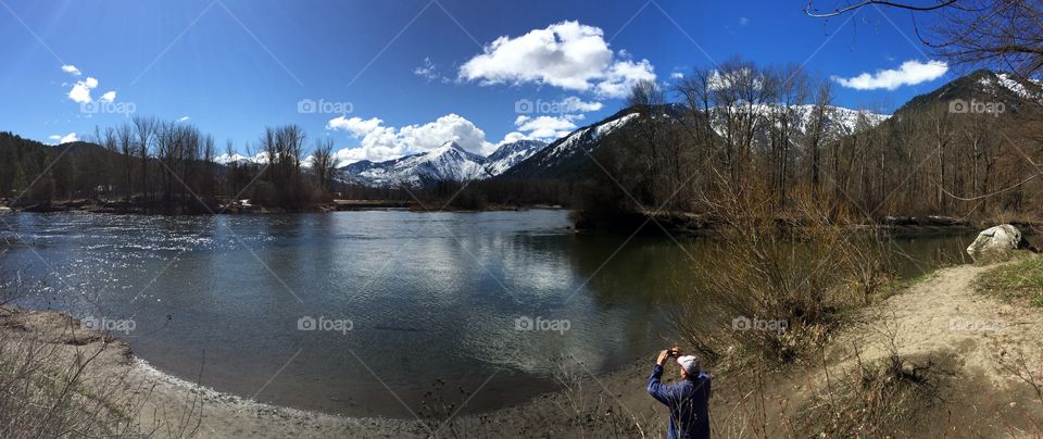 Man photographing the view of lake