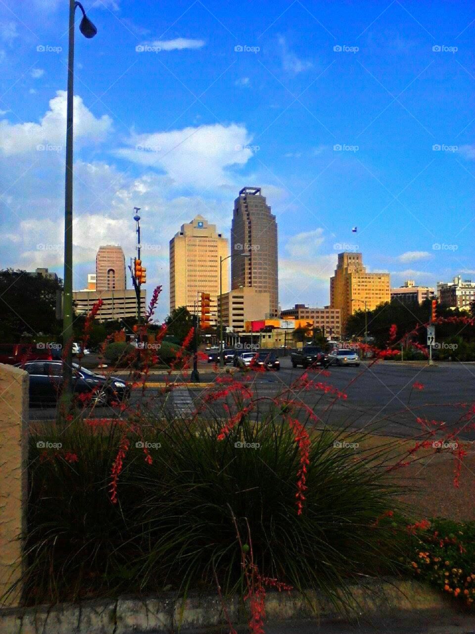 Downtown San Antonio city skyline, a faint rainbow to the right of the tallest building