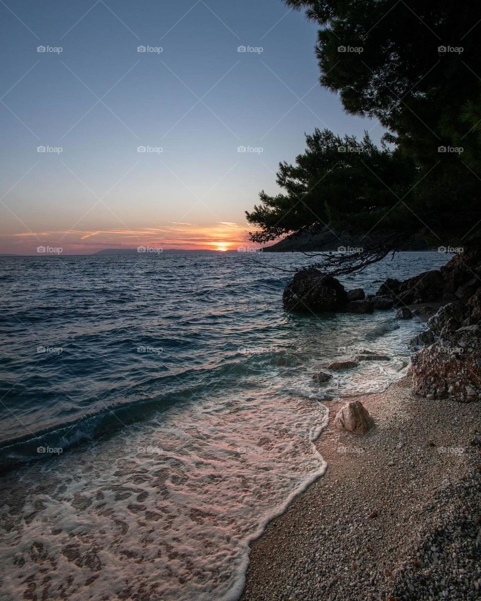 A Beach with a sunset in the background