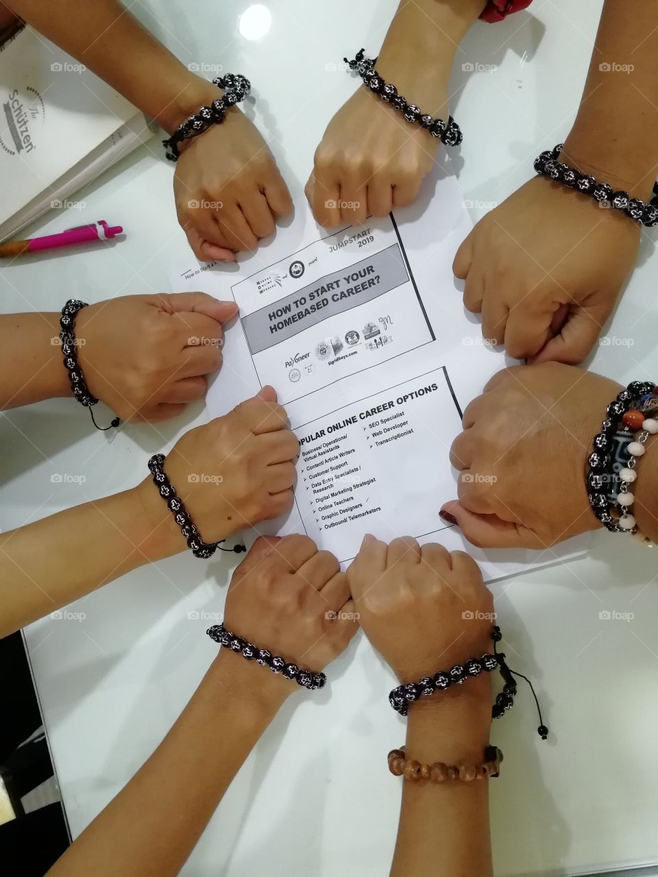 This photo is about working together. Eight women gathered together to upgrade their online skills. The uniform bracelets are our "certificates" after finishing the workshop.