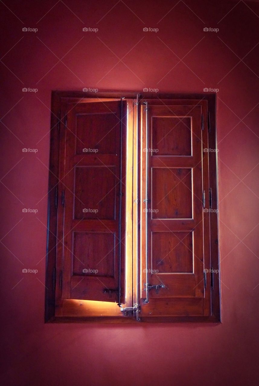 Wooden window with red wall