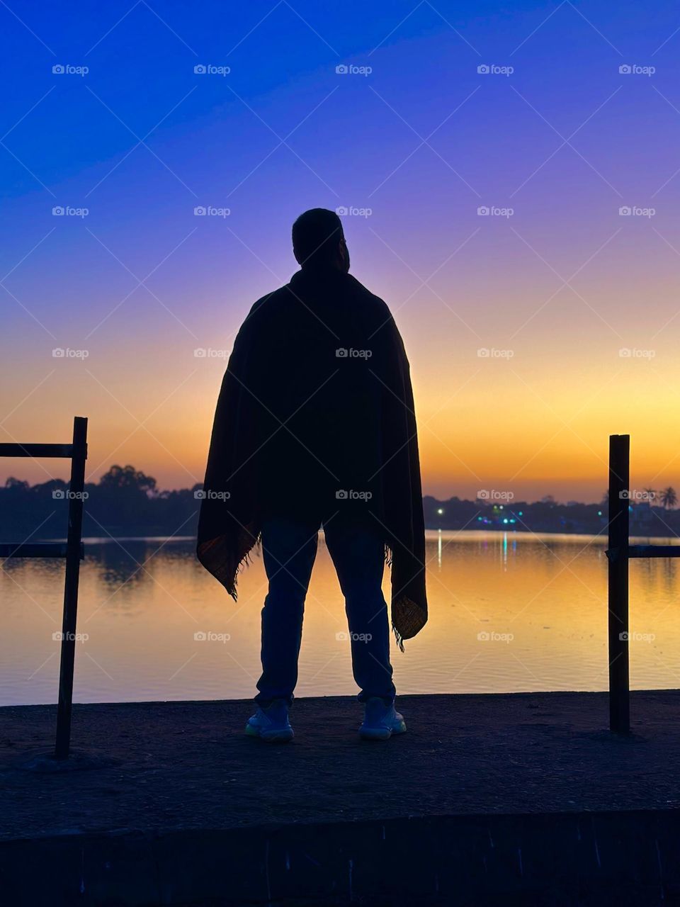 silhouette of man standing towards sunset dawn