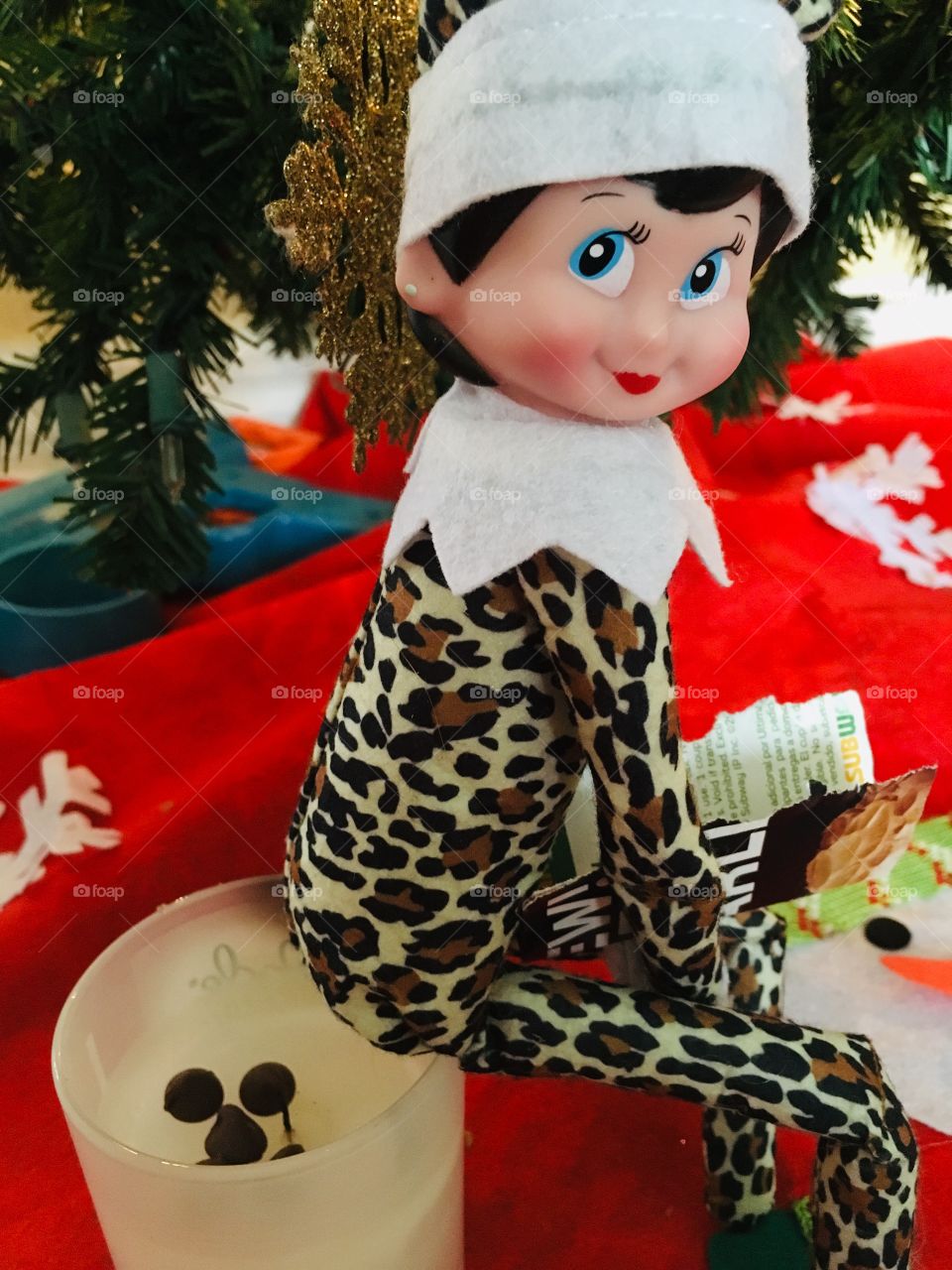 Naughty elf making chocolate chips wearing leopard print 