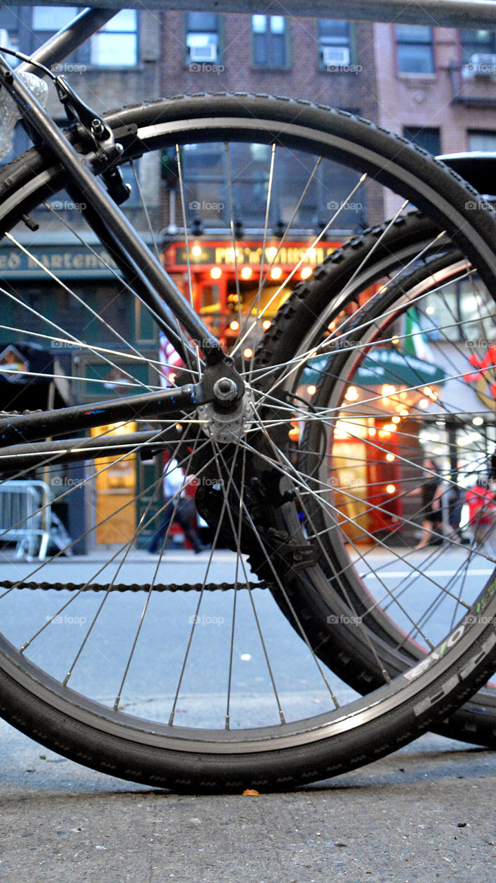 Low angle view of bicycle wheels against the background of a New York City street