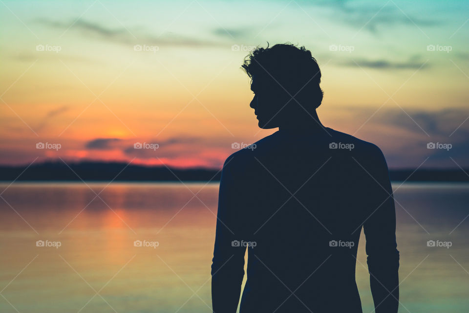 Silhouette of a Man at Sunset in the Water