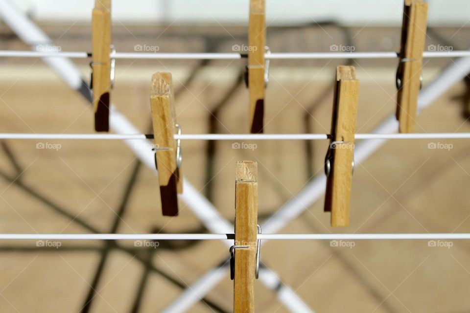 Wooden clothespins priced symmetrically on metal clothesline