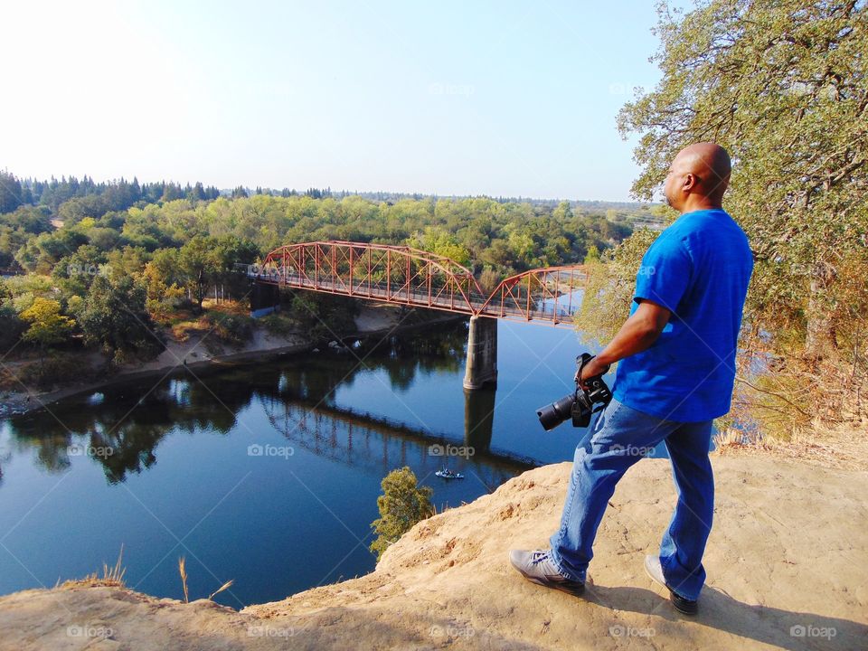 photographers taking in the view from the top of the cliff