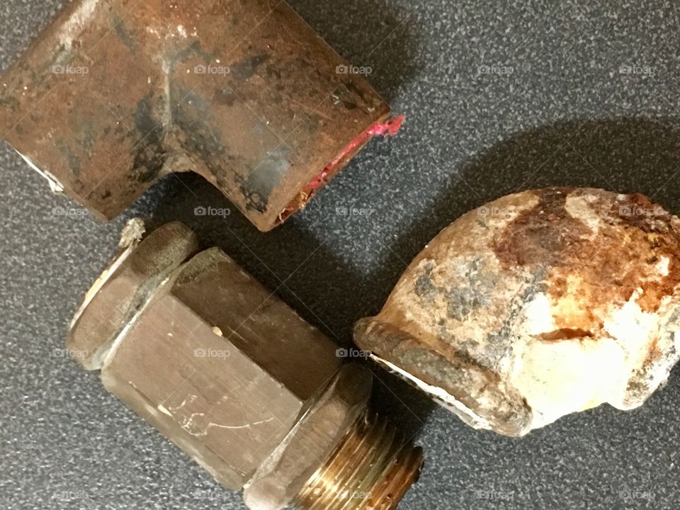 From above: collection of rusted corroded pipes removed by plumber contractor home renovations 