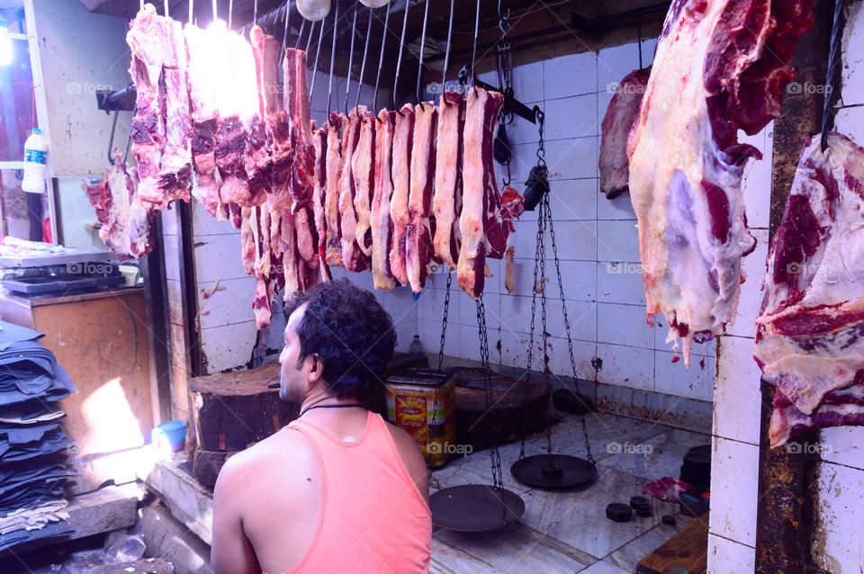 Burrabazar, Kolkata, India MAY, 2017: A seller is selling fresh raw red meat. Butcher shop for display. Burrabazar ( Bara Bazaar) is a marketplace, largest wholesale butchery markets store in India.