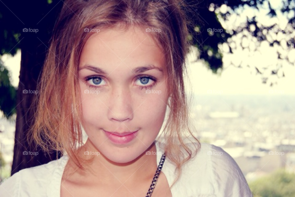 A young girl in Paris. Close up of a girls face. A girl visiting Paris