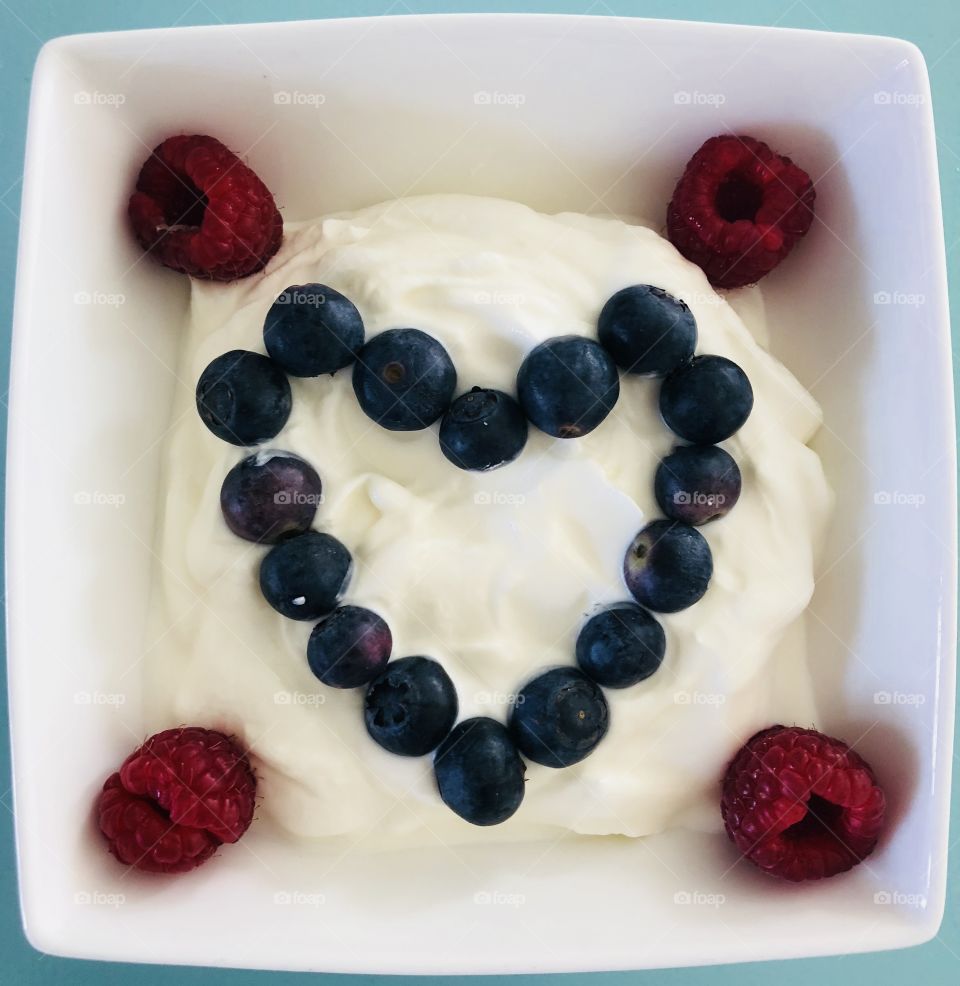 Morning routine: Healthy breakfast bowl of yoghurt covered with berry fruits, blueberries and raspberries