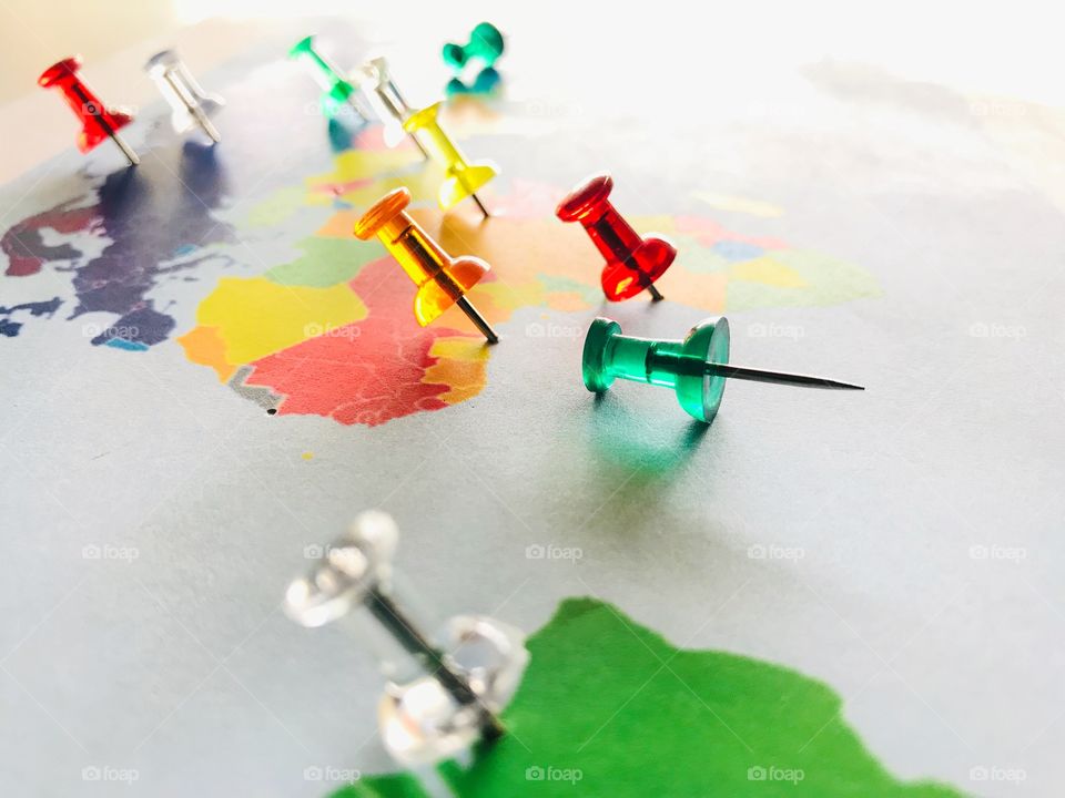 Colorful push pins on a colorful map