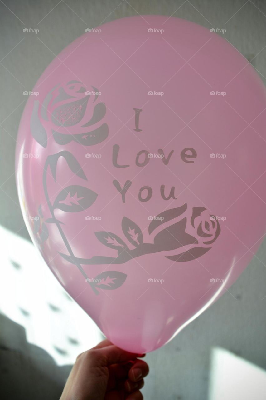 baby pink balloon in the hand