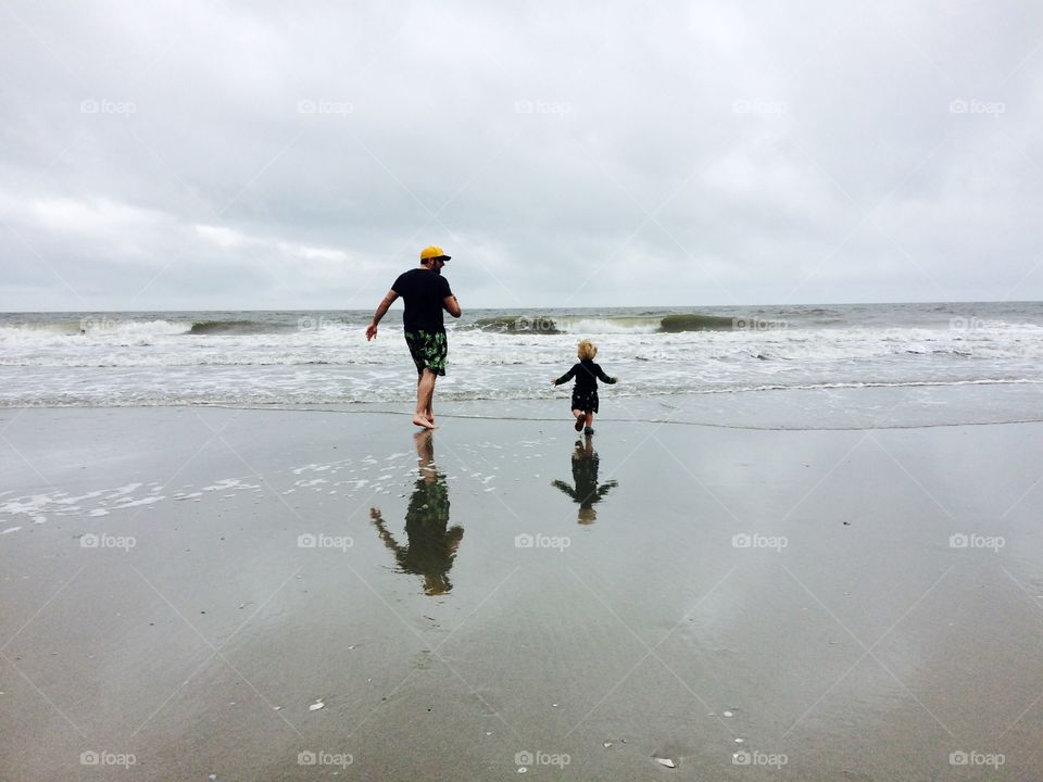 Me and my son walking into the surf of Folly Beach SC. 