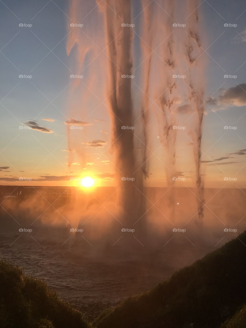 View from inside the waterfall at sunset