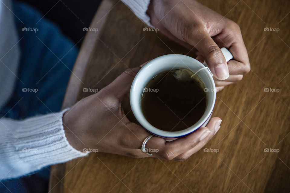 Hands holding a cup of tea