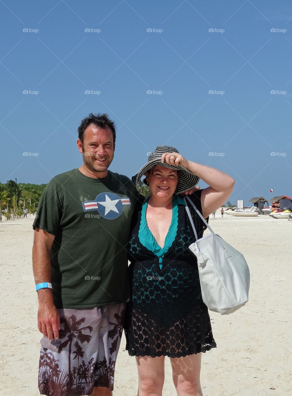 Americans Abroad. American Tourists On A Tropical Beach
