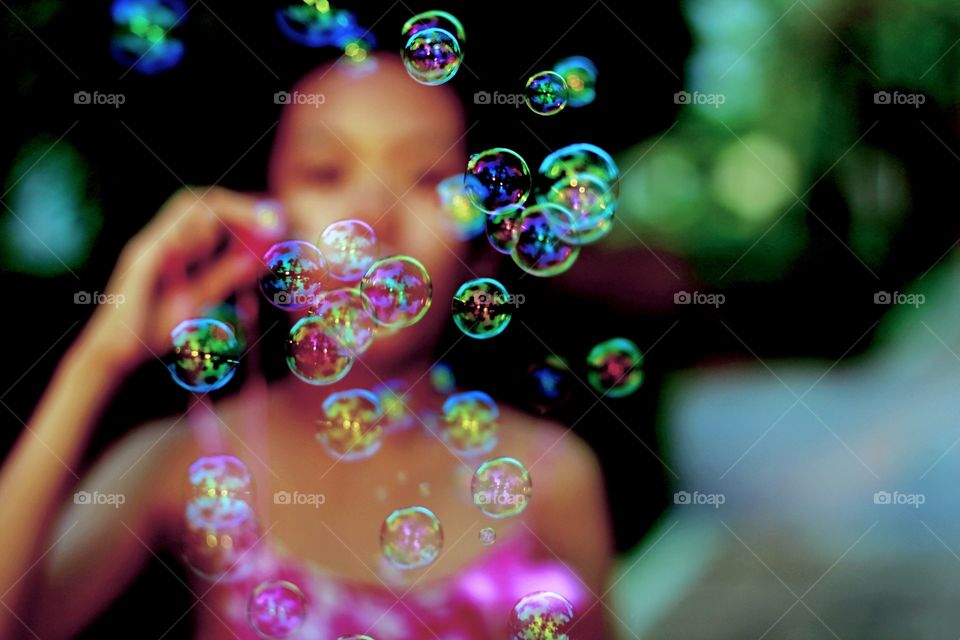 Girl playing soap bubble 
