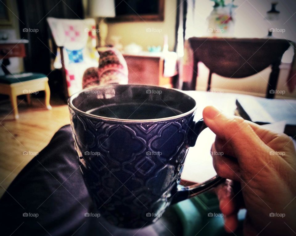 Winter beverage of hot coffee & cozy slippers at home