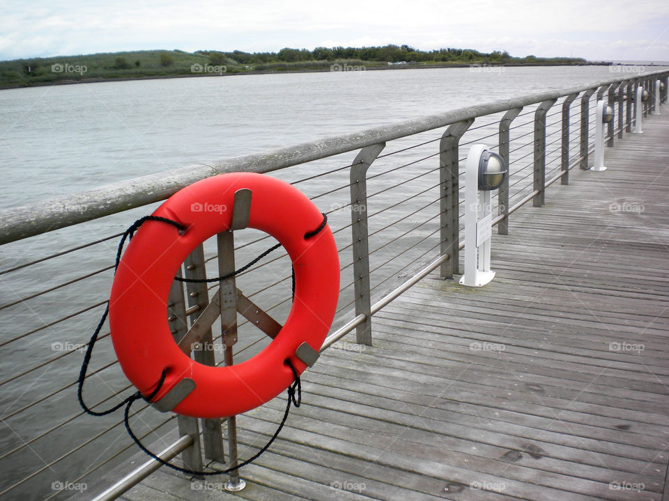 Red life preserver on the dock of a ferry pier