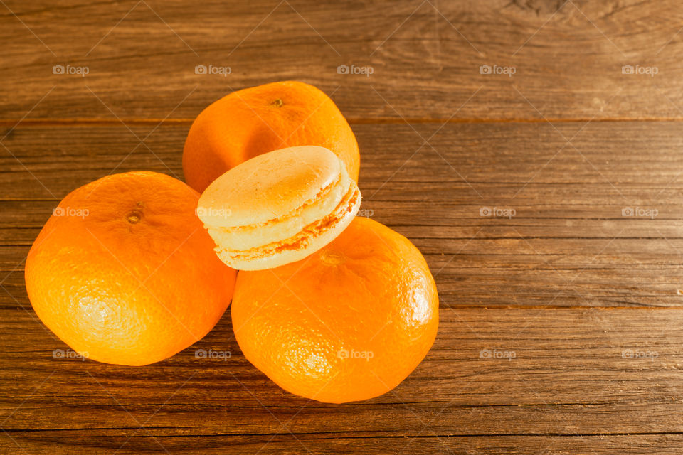 three tangerines and a tangerine macaron
