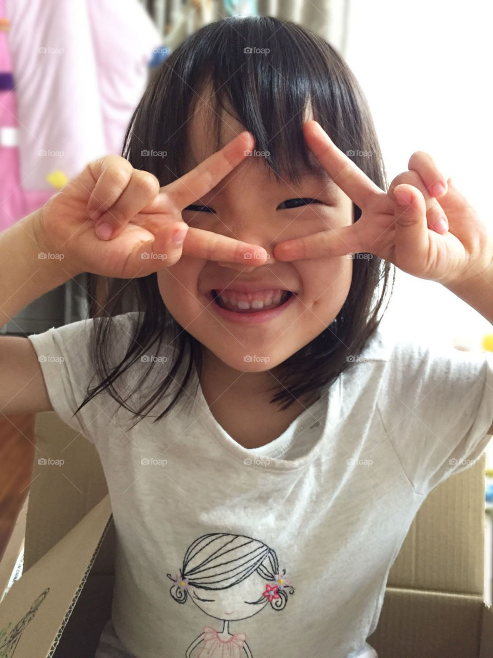 A little girl posing with a smile toward the camera 