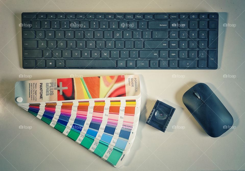 Working place : keyboard, pantone, mouse and magnifier.