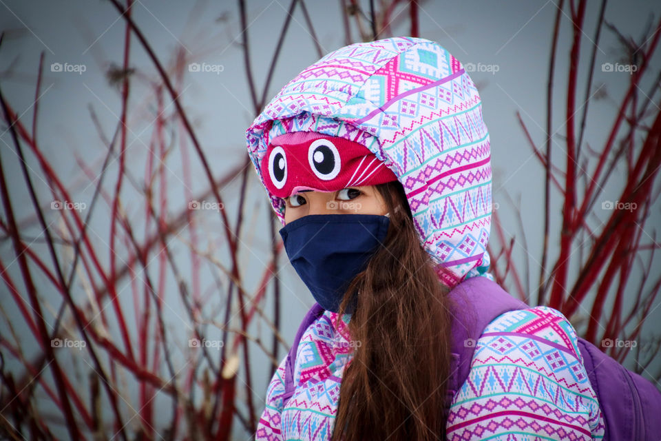 Cute girl in a navy blue face mask