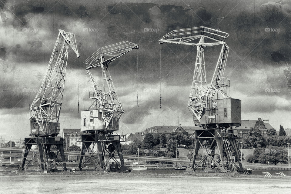 Cranes and small ships in the harbor