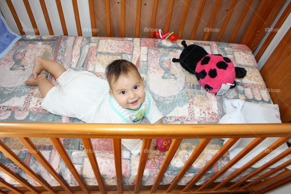 Elevated view of a baby in wooden bed