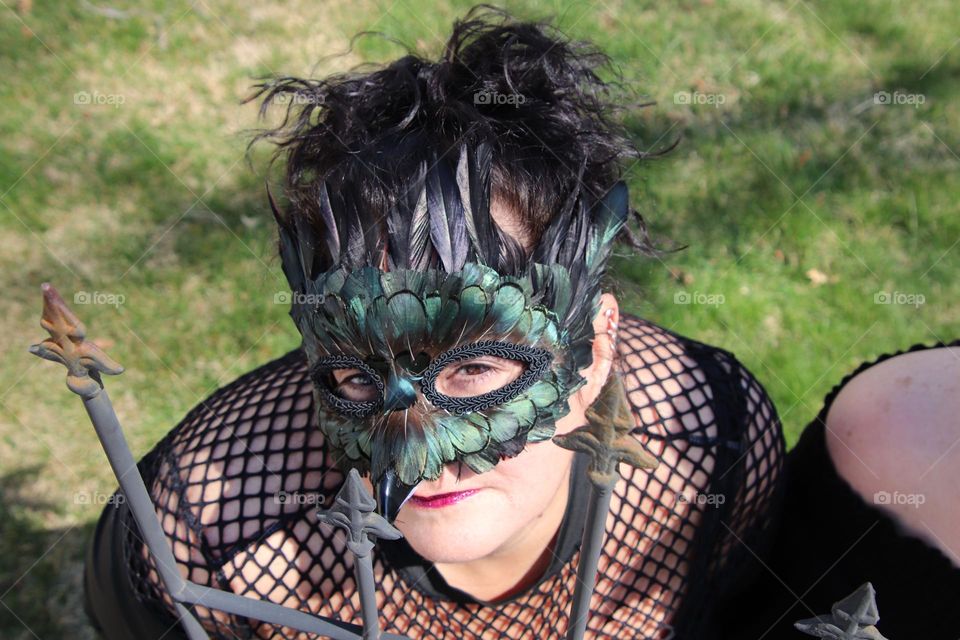 Woman wearing feather masquerade masks