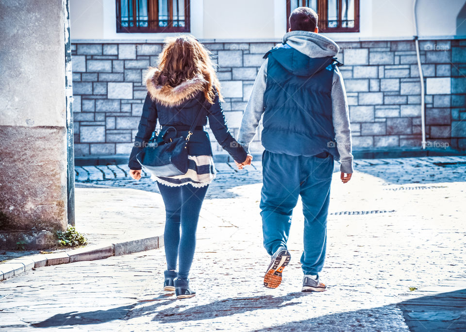 Young Couple In Love Walking In The Street Holding Hands
