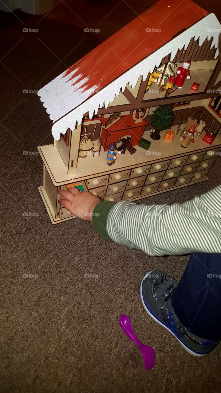 opening the first drawer of the advent calender. wooden toy shop advent calender. drawer full of stickers