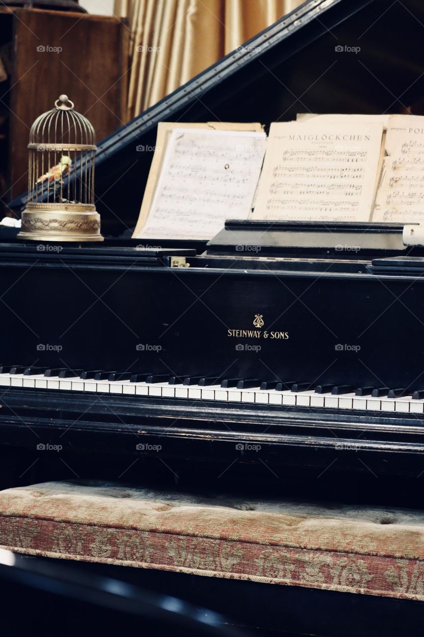 Vintage old piano and “bird in a cage” music box 
