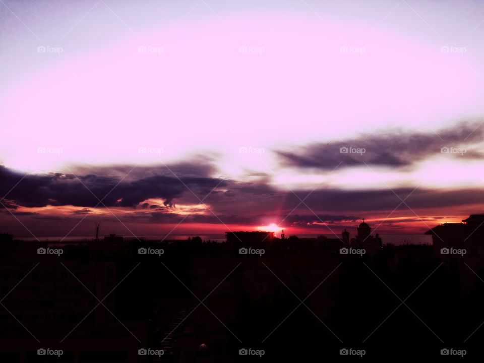 amazing pink sunset, city and sea. perfect sky