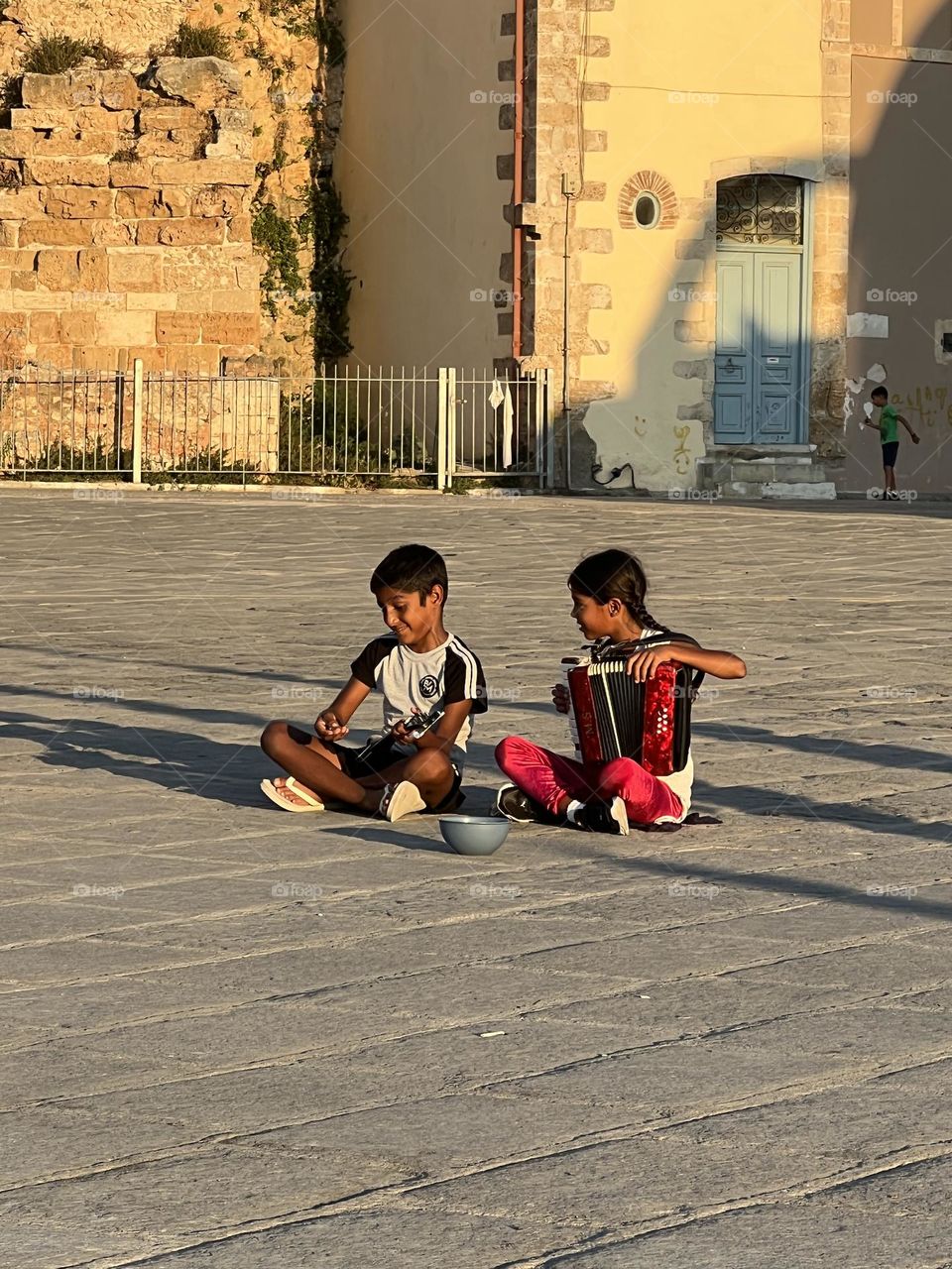 Two children playing in the square centre 
