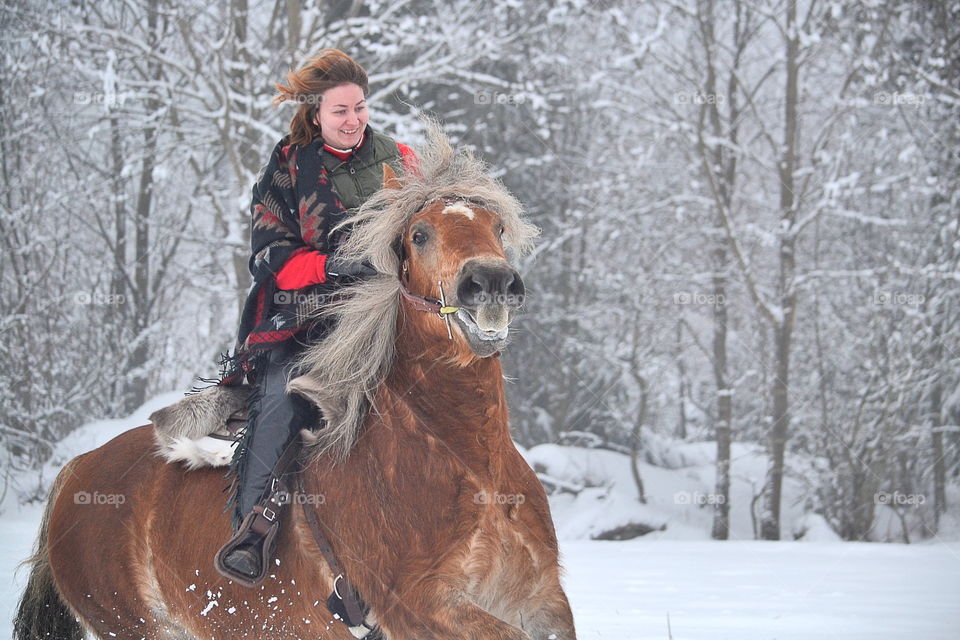 Woman riding her horse