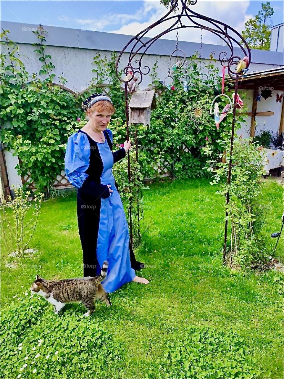 This nostalgic lady wears a Renaissance to medieval inspired gown she also wears when playing the lute in the „Agnes Bernauer“ festival in „Straubing“, „Bavaria“, Germany about a historic person from the 15th century. 2024. Hypnotic Productions