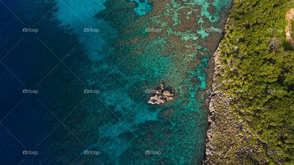 Aerial view of coral reefs and shore line.
