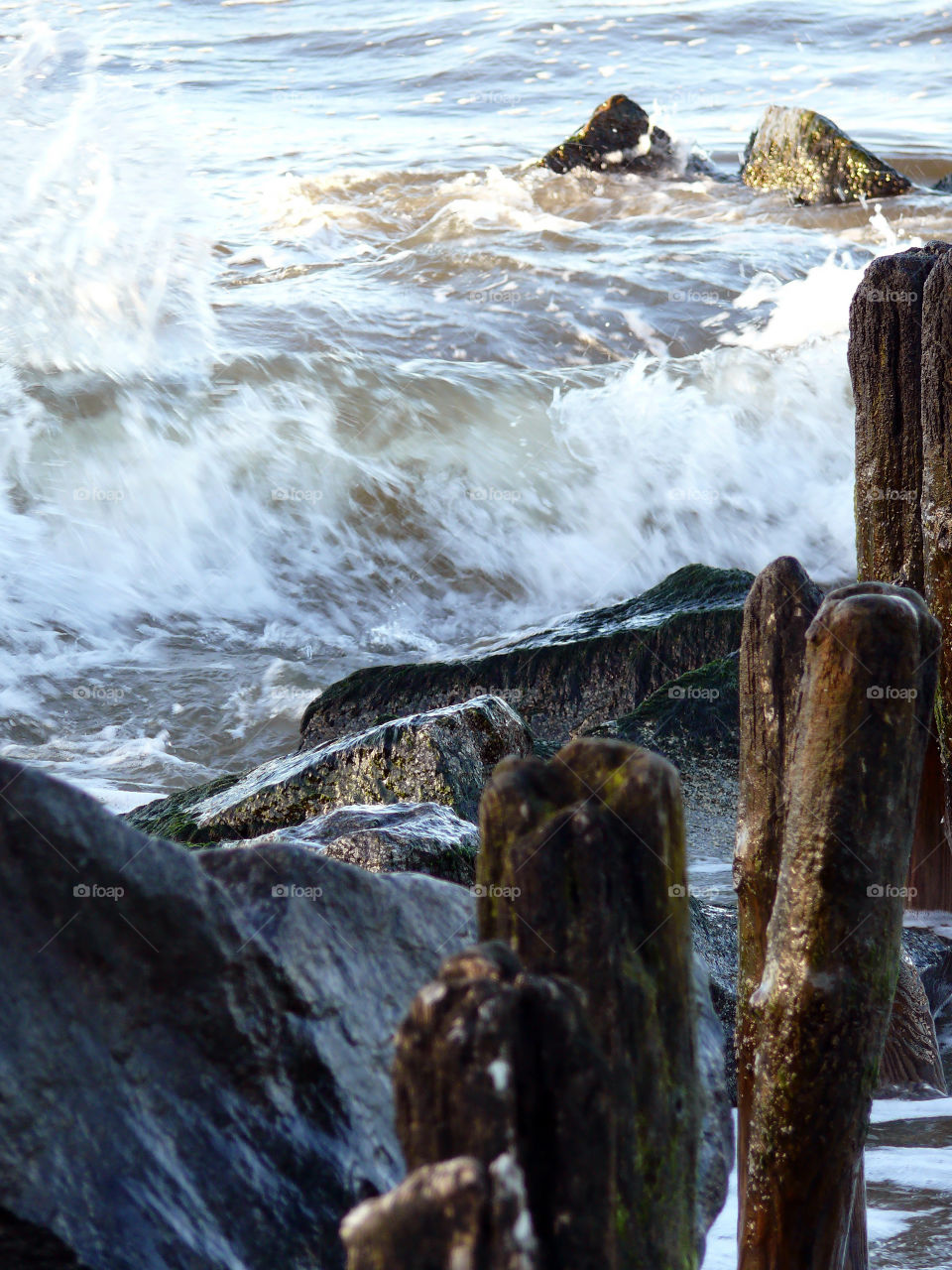 Motion shot of the Baltic Sea clashing against rocks in Niechorze, Poland.